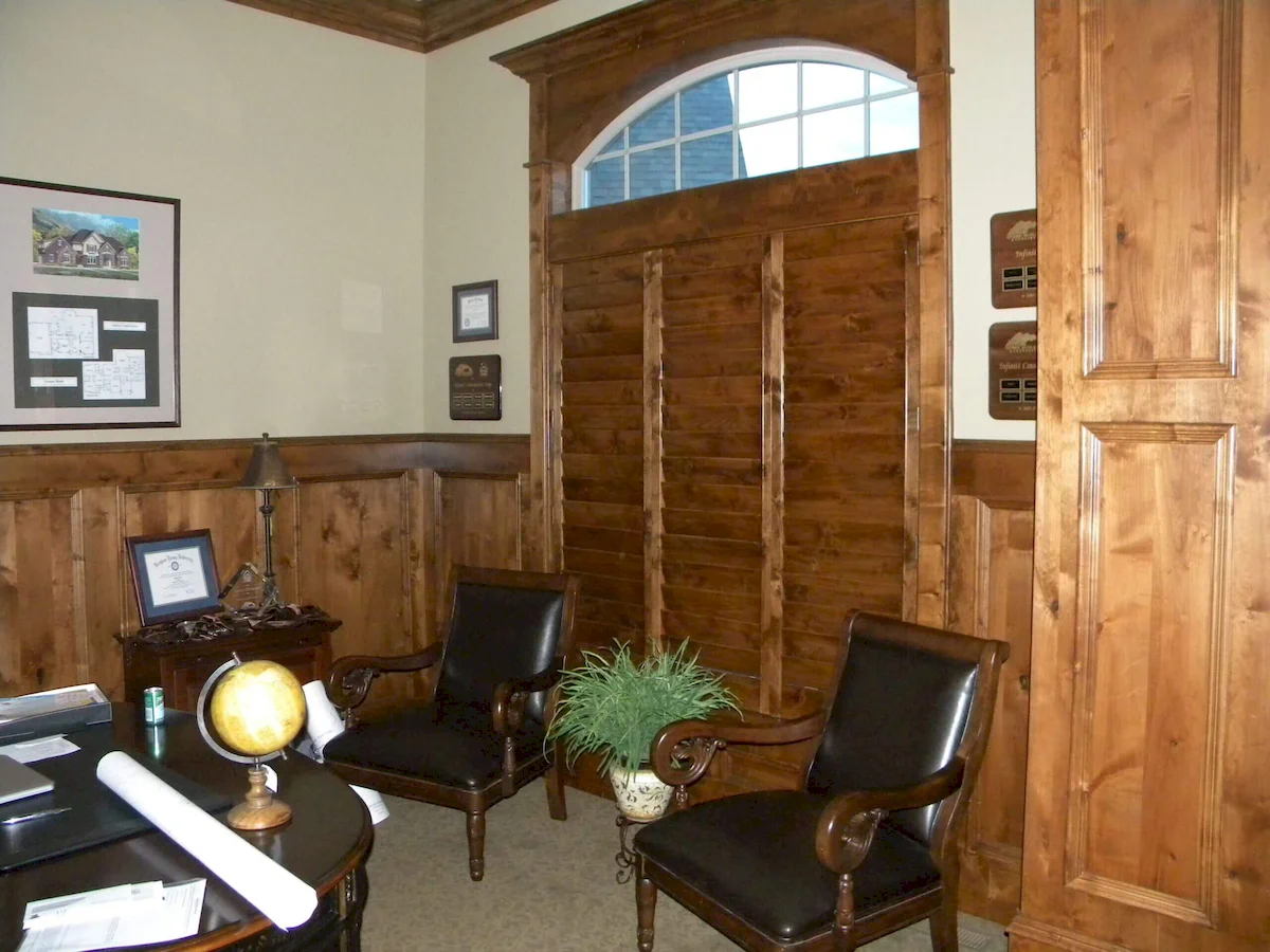 office with indoor custom plantation shutters made of wood