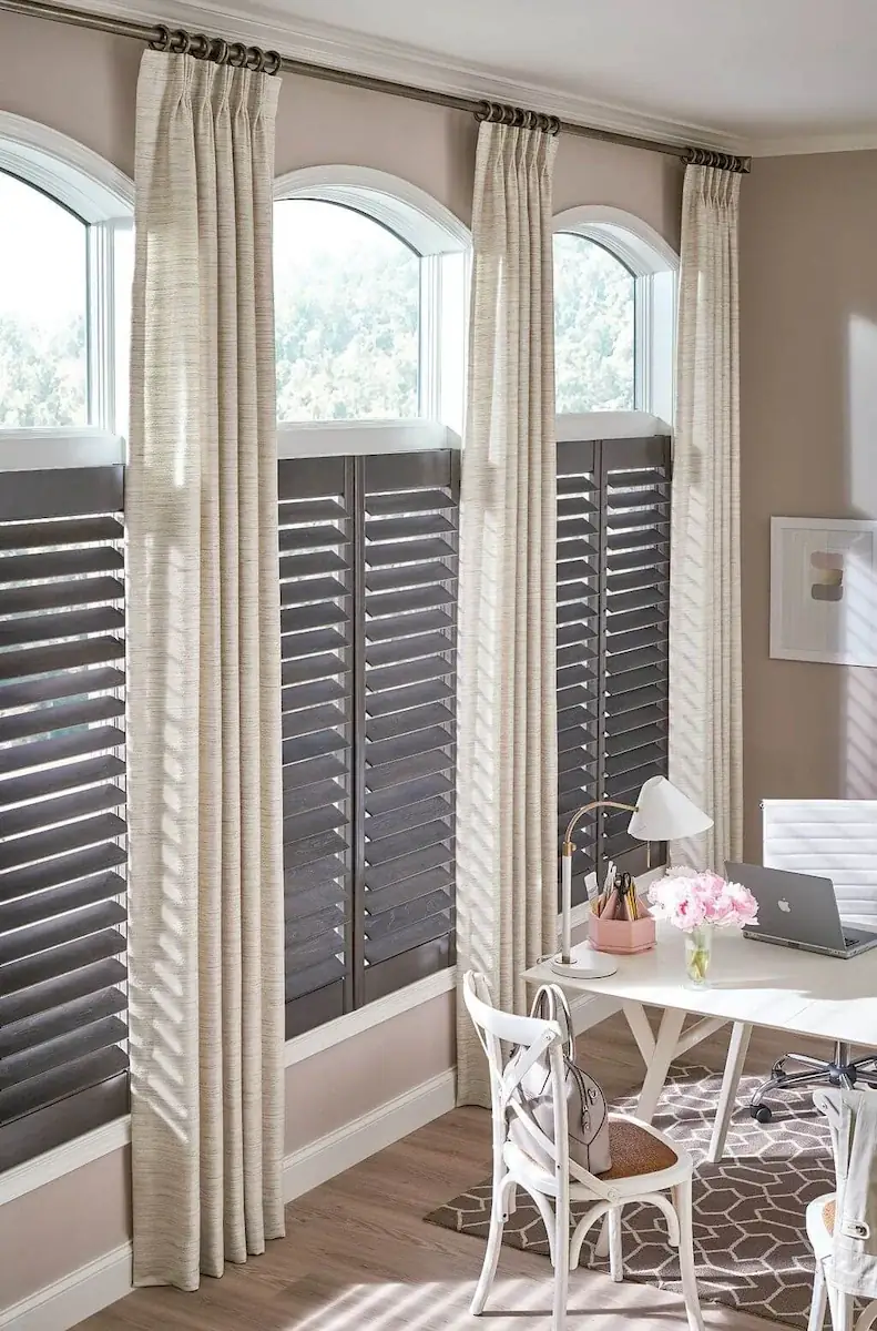 office with with drapes, float topinside custom plantation shutters made of wood