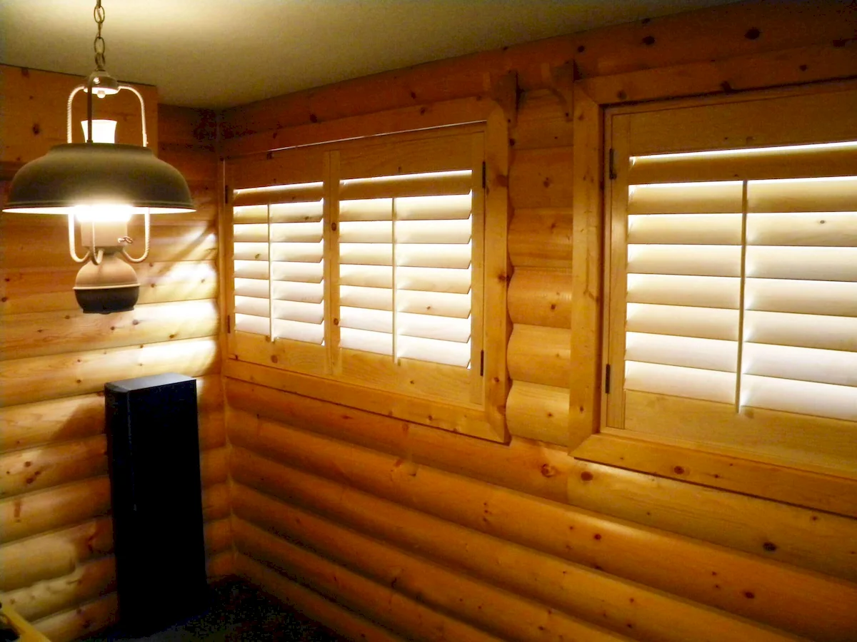 basement with indoor custom plantation shutters made of wood
