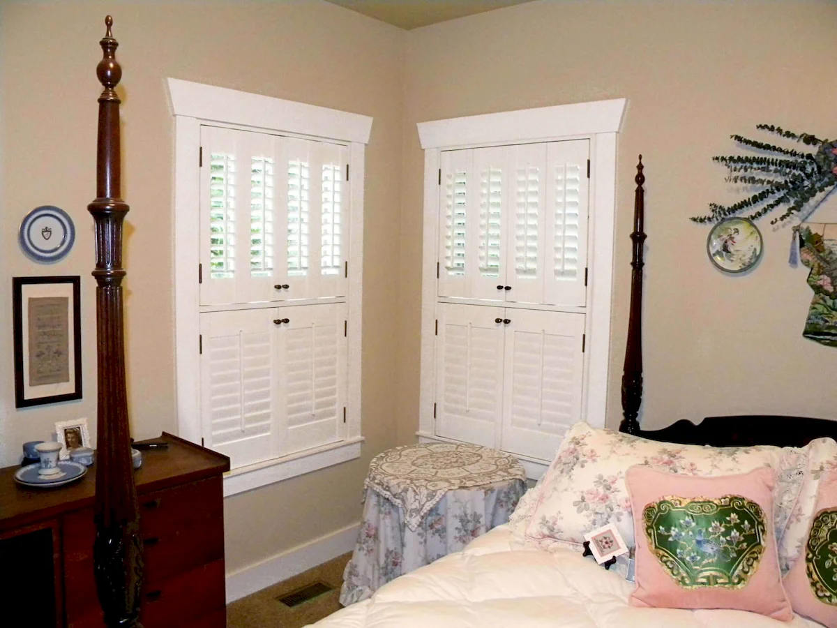 bedroom with bi-fold inside custom plantation shutters made of wood