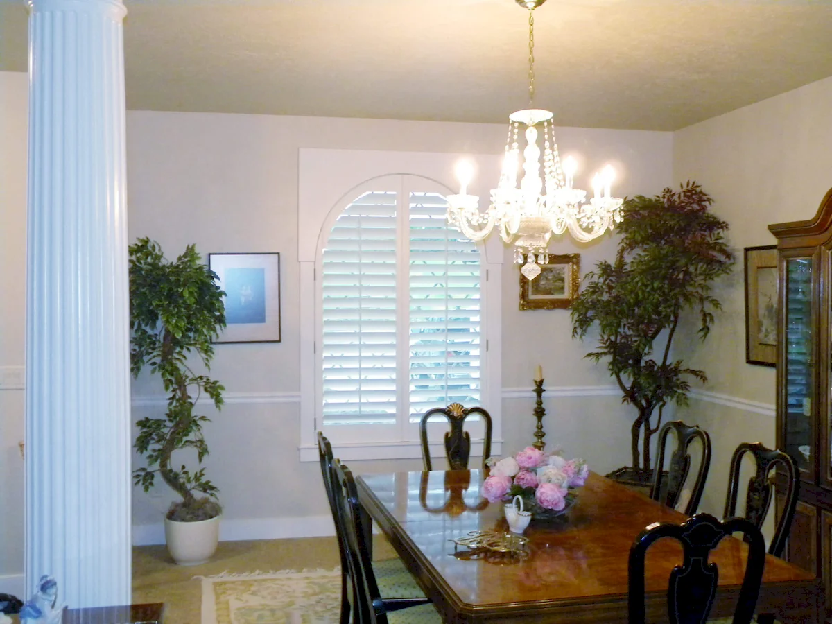 dining room with full-height interior custom plantation shutters made of wood