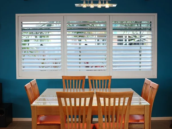 dining room with interior custom plantation shutters made of wood